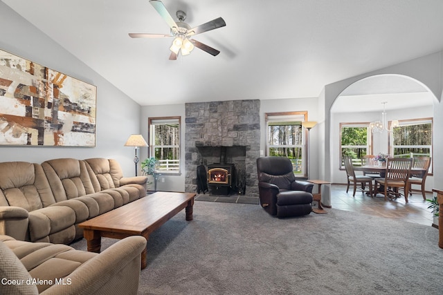699 W Ranch Ct, Rathdrum, ID 83858 - carpeted living area with a ceiling fan, plenty of natural light, a wood stove, and vaulted ceiling