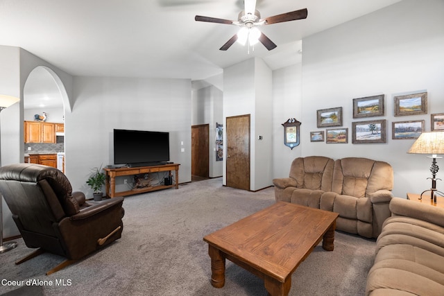 699 W Ranch Ct, Rathdrum, ID 83858 - living area featuring light carpet, a ceiling fan, arched walkways, and a towering ceiling