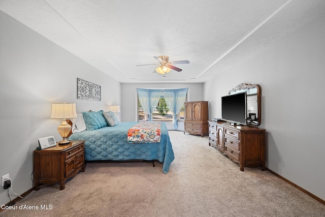 699 W Ranch Ct, Rathdrum, ID 83858 - bedroom with light colored carpet, a textured ceiling, a ceiling fan, and access to exterior