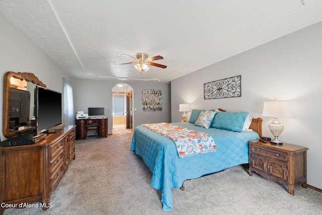 699 W Ranch Ct, Rathdrum, ID 83858 - bedroom featuring light carpet, arched walkways, ceiling fan, and ensuite bathroom