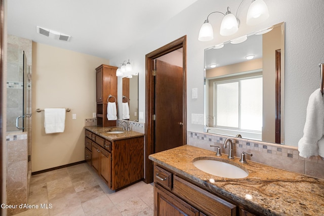 699 W Ranch Ct, Rathdrum, ID 83858 - bathroom featuring two vanities, tasteful backsplash, and a shower stall