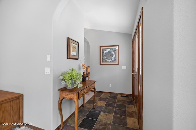 699 W Ranch Ct, Rathdrum, ID 83858 - hallway with arched walkways, stone finish flooring, and vaulted ceiling