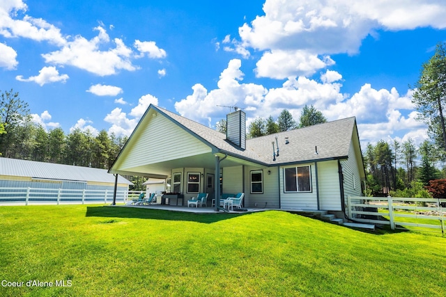 699 W Ranch Ct, Rathdrum, ID 83858 - back of house with a patio, a chimney, and roof with shingles