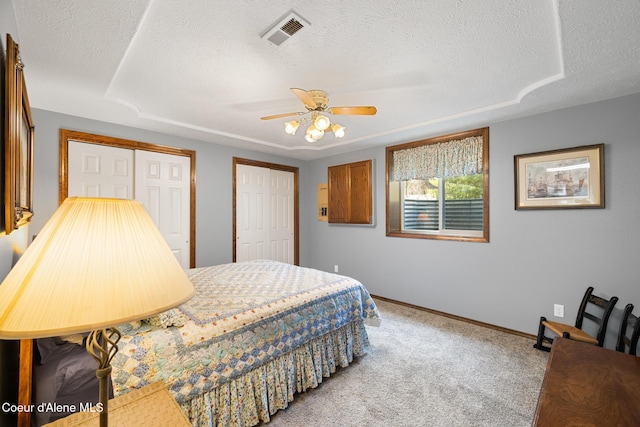 699 W Ranch Ct, Rathdrum, ID 83858 - bedroom featuring a textured ceiling, multiple closets, carpet flooring, and a ceiling fan