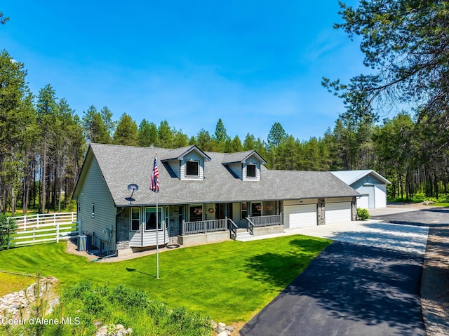 699 W Ranch Ct, Rathdrum, ID 83858 - cape cod home with covered porch, driveway, a garage, and roof with shingles