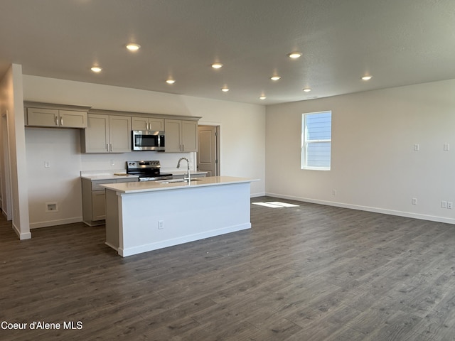 5103 E Rigel Ln, Post Falls, ID 83854 - kitchen with appliances with stainless steel finishes, gray cabinets, a center island with sink, light countertops, and dark wood-type flooring