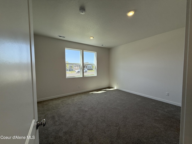 5103 E Rigel Ln, Post Falls, ID 83854 - empty room with dark carpet, a smoke detector, a textured ceiling, and recessed lighting