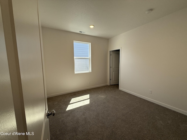 5103 E Rigel Ln, Post Falls, ID 83854 - unfurnished room featuring dark carpet and a smoke detector