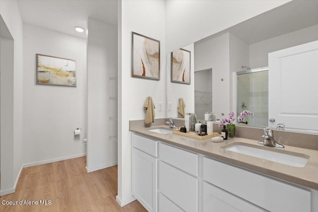 5103 E Norma Ave, Post Falls, ID 83854 - bathroom with a shower stall, wood finished floors, double vanity, and a walk in closet