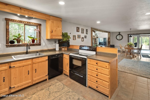 4119 Colburn Culver, Sandpoint, ID 83864 - kitchen featuring black appliances, a peninsula, light brown cabinets, recessed lighting, and light tile patterned floors