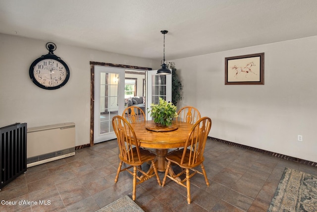 4119 Colburn Culver, Sandpoint, ID 83864 - dining area featuring heating unit, radiator heating unit, and stone finish flooring
