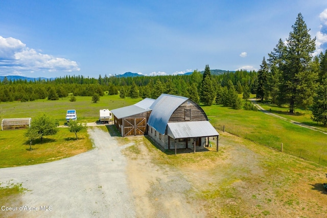 4119 Colburn Culver, Sandpoint, ID 83864 - aerial view of property and surrounding area with a heavily wooded area and a mountain backdrop