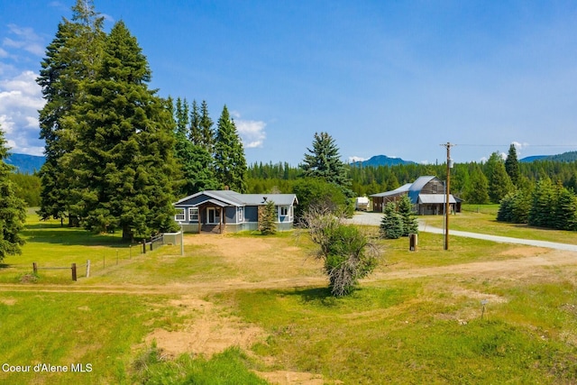 4119 Colburn Culver, Sandpoint, ID 83864 - view of front of property with driveway, a mountain view, and a forest view