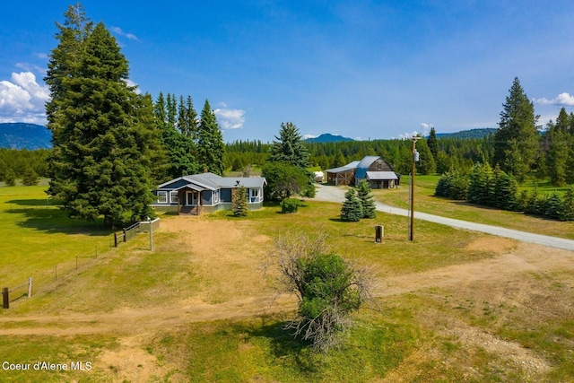 4119 Colburn Culver, Sandpoint, ID 83864 - view of front of property with dirt driveway, a mountain view, a view of rural / pastoral area, and a wooded view