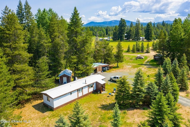4119 Colburn Culver, Sandpoint, ID 83864 - aerial view of property and surrounding area with a mountainous background and a heavily wooded area