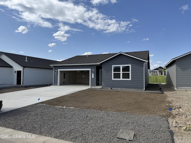 5149 E Rigel Ln, Post Falls, ID 83854 - ranch-style house with concrete driveway, a garage, and roof with shingles