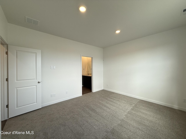 5149 E Rigel Ln, Post Falls, ID 83854 - unfurnished bedroom with dark colored carpet, recessed lighting, and ensuite bath