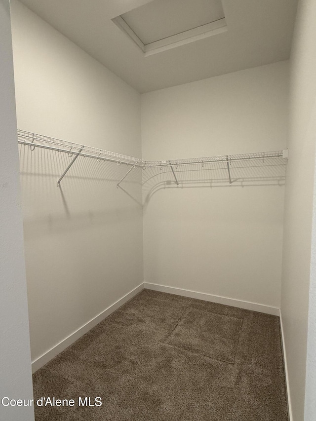 5149 E Rigel Ln, Post Falls, ID 83854 - walk in closet featuring attic access and dark colored carpet