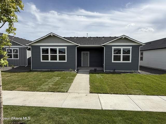 5149 E Rigel Ln, Post Falls, ID 83854 - view of front facade featuring a front lawn and roof with shingles