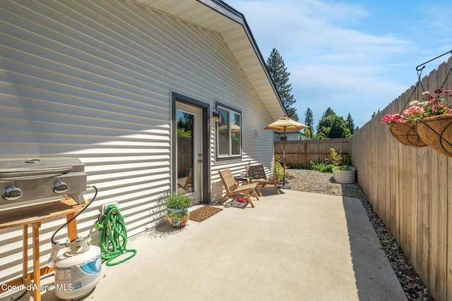 1623 E Boyd Ave, Coeur Dalene, ID 83814 - fenced backyard featuring a patio area and a grill