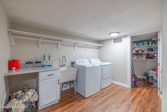 1623 E Boyd Ave, Coeur Dalene, ID 83814 - washroom with separate washer and dryer, light wood-type flooring, and a textured ceiling