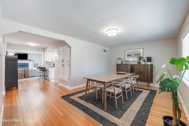 1623 E Boyd Ave, Coeur Dalene, ID 83814 - dining room with light wood-style floors and arched walkways