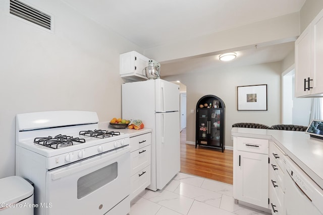 1623 E Boyd Ave, Coeur Dalene, ID 83814 - kitchen featuring white appliances, light marble finish flooring, white cabinets, and light countertops