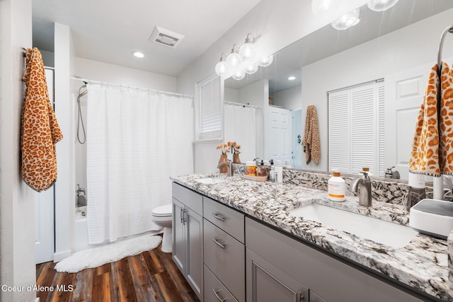 1623 E Boyd Ave, Coeur Dalene, ID 83814 - bathroom featuring double vanity, wood finished floors, shower / tub combo with curtain, and recessed lighting