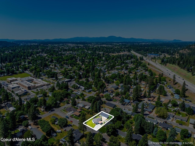 1623 E Boyd Ave, Coeur Dalene, ID 83814 - aerial view of property's location with property boundaries highlighted and a mountain backdrop