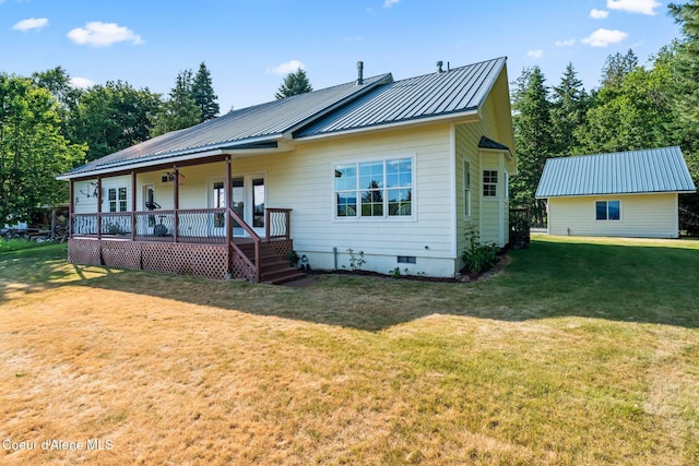 182 Sunnyside Rd, Sandpoint, ID 83864 - view of front of house with crawl space, a front yard, covered porch, and a metal roof