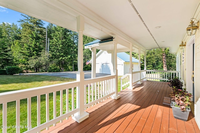 182 Sunnyside Rd, Sandpoint, ID 83864 - wooden porch with a lawn, view of scattered trees, and an outbuilding