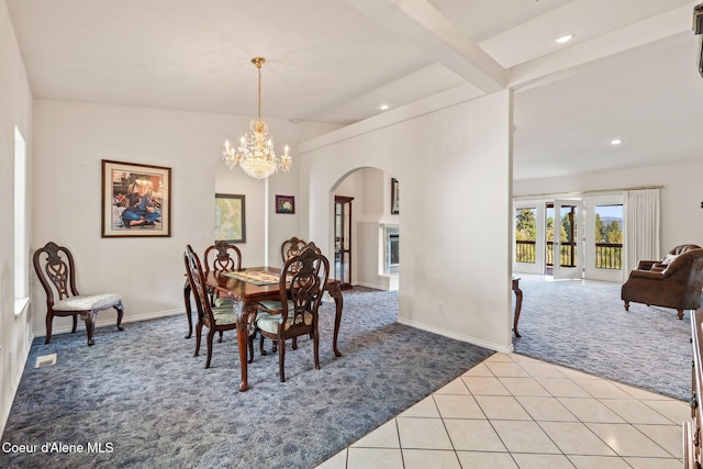 182 Sunnyside Rd, Sandpoint, ID 83864 - carpeted dining room featuring arched walkways, a chandelier, recessed lighting, tile patterned flooring, and beam ceiling