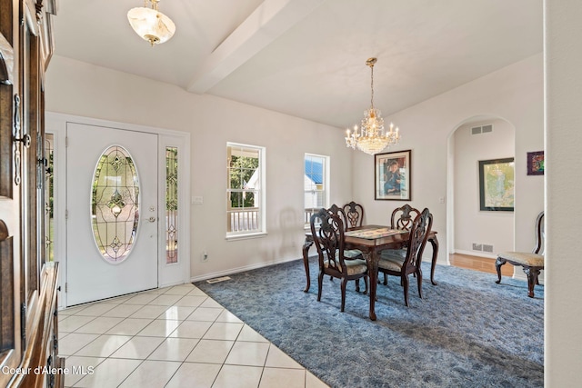 182 Sunnyside Rd, Sandpoint, ID 83864 - entrance foyer with a chandelier, light tile patterned floors, arched walkways, and beam ceiling