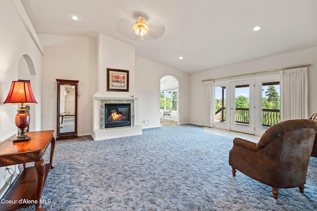 182 Sunnyside Rd, Sandpoint, ID 83864 - carpeted living room featuring lofted ceiling, a fireplace, recessed lighting, arched walkways, and ceiling fan