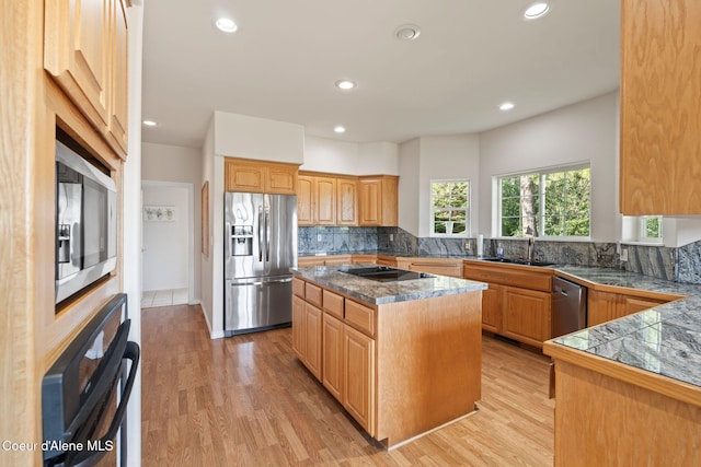 182 Sunnyside Rd, Sandpoint, ID 83864 - kitchen featuring black appliances, tasteful backsplash, recessed lighting, light wood-style flooring, and tile countertops