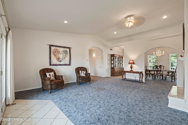 182 Sunnyside Rd, Sandpoint, ID 83864 - living area featuring arched walkways, light colored carpet, vaulted ceiling, a chandelier, and recessed lighting