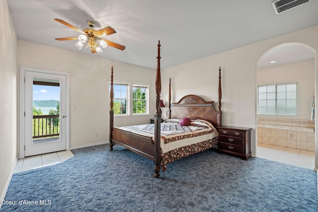 182 Sunnyside Rd, Sandpoint, ID 83864 - carpeted bedroom with arched walkways, access to outside, tile patterned floors, ensuite bath, and a ceiling fan