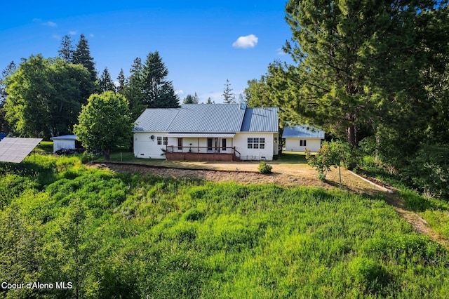 182 Sunnyside Rd, Sandpoint, ID 83864 - view of front of home with a metal roof and a wooden deck