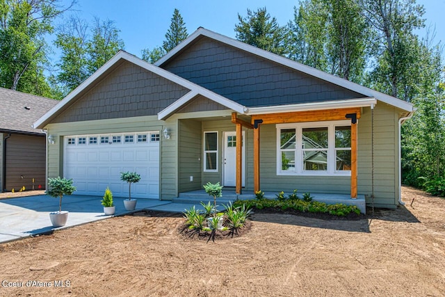 225 Jasper Loop, Ponderay, ID 83852 - view of front of property with driveway, a garage, and covered porch