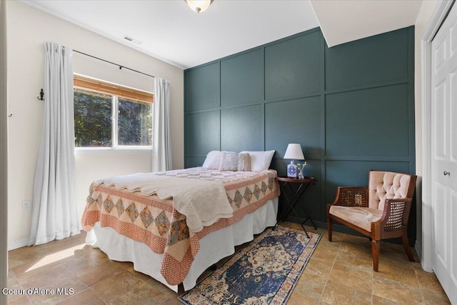 2682 W Iago St, Post Falls, ID 83854 - bedroom with stone finish flooring and a decorative wall