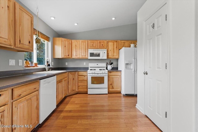 2682 W Iago St, Post Falls, ID 83854 - kitchen featuring white appliances, dark countertops, light wood-style floors, vaulted ceiling, and recessed lighting