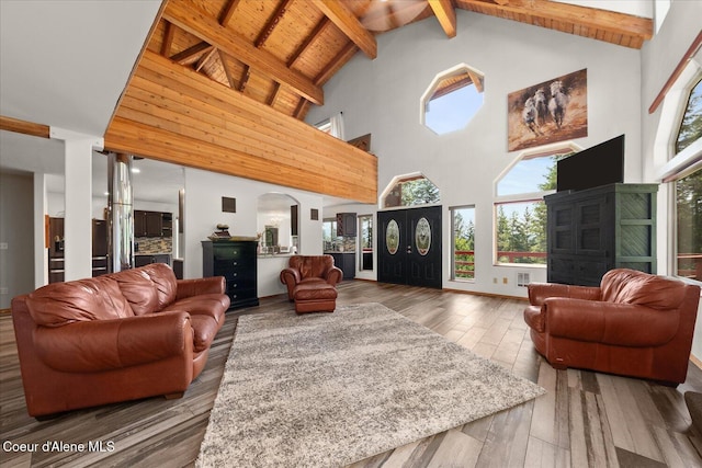 299 Oak Ter, Cocolalla, ID 83813 - living room with high vaulted ceiling, healthy amount of natural light, wood-type flooring, arched walkways, and beamed ceiling