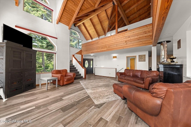299 Oak Ter, Cocolalla, ID 83813 - living area featuring a wood ceiling with exposed beams, high vaulted ceiling, wood finished floors, and stairs