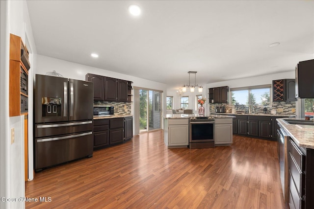 299 Oak Ter, Cocolalla, ID 83813 - kitchen featuring stainless steel appliances, backsplash, a center island, plenty of natural light, and recessed lighting