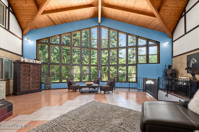 299 Oak Ter, Cocolalla, ID 83813 - tiled living area featuring high vaulted ceiling, plenty of natural light, and a wood ceiling with exposed beams