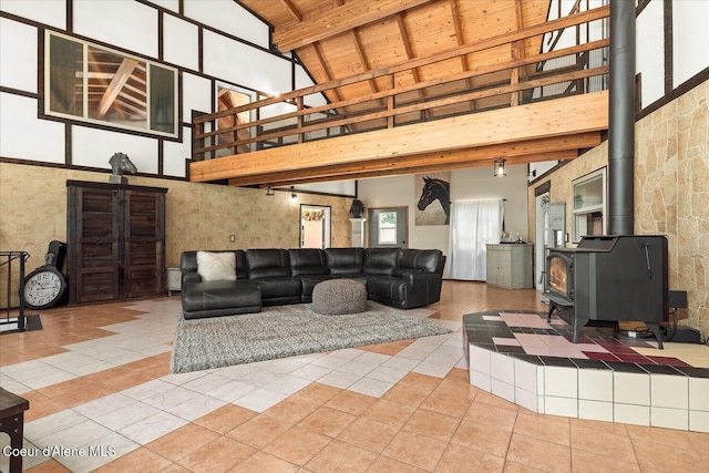 299 Oak Ter, Cocolalla, ID 83813 - tiled living room featuring high vaulted ceiling, a wood stove, and a wooden ceiling with exposed beams