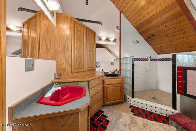 299 Oak Ter, Cocolalla, ID 83813 - bathroom with vanity, tiled shower, vaulted ceiling, and wooden ceiling