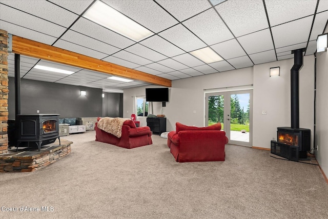 299 Oak Ter, Cocolalla, ID 83813 - carpeted living room featuring a wood stove, french doors, and a paneled ceiling