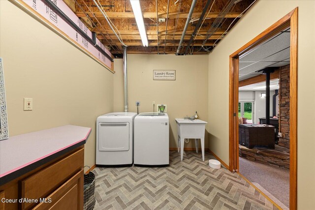 299 Oak Ter, Cocolalla, ID 83813 - laundry room with washing machine and clothes dryer and a wood stove
