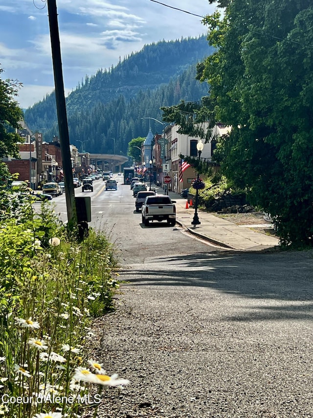 408 High Bank St, Wallace, ID 83873 - view of asphalt street with street lights, sidewalks, a mountain view, and curbs
